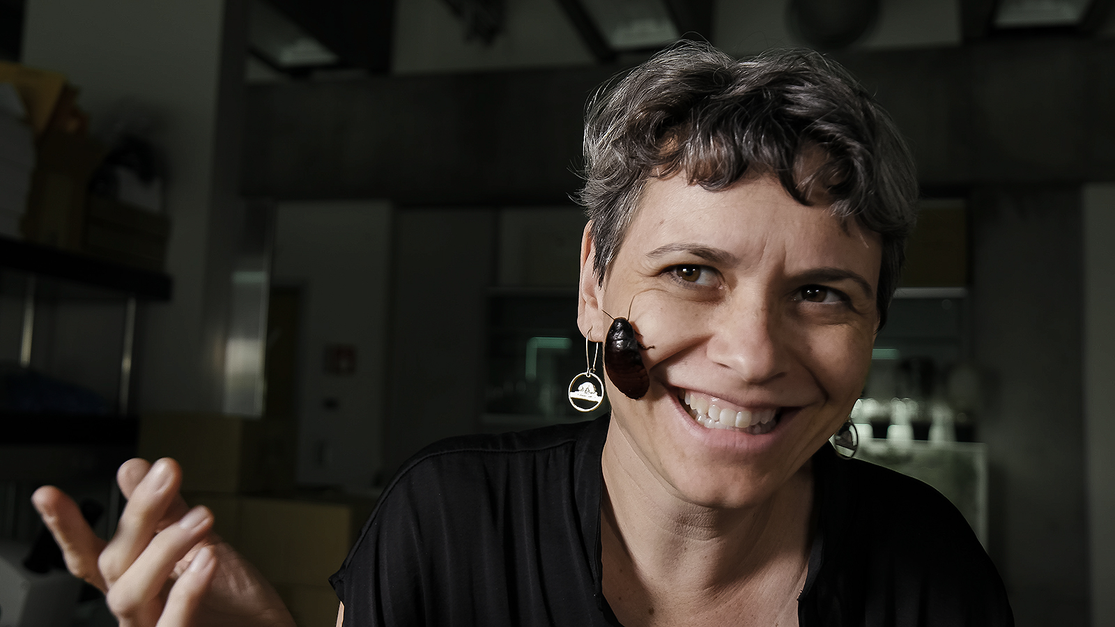 smiling woman with bug on her face