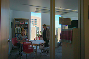 woman teaching a student in her office