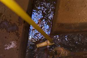 Getting a sample of sewage.