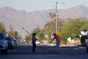 Wide shot of workers getting a sewage sample.