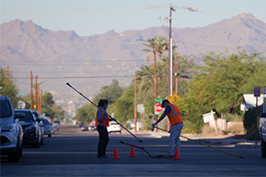 Wide shot of workers getting a sewage sample. 